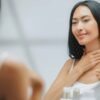 woman applying cream to her neck