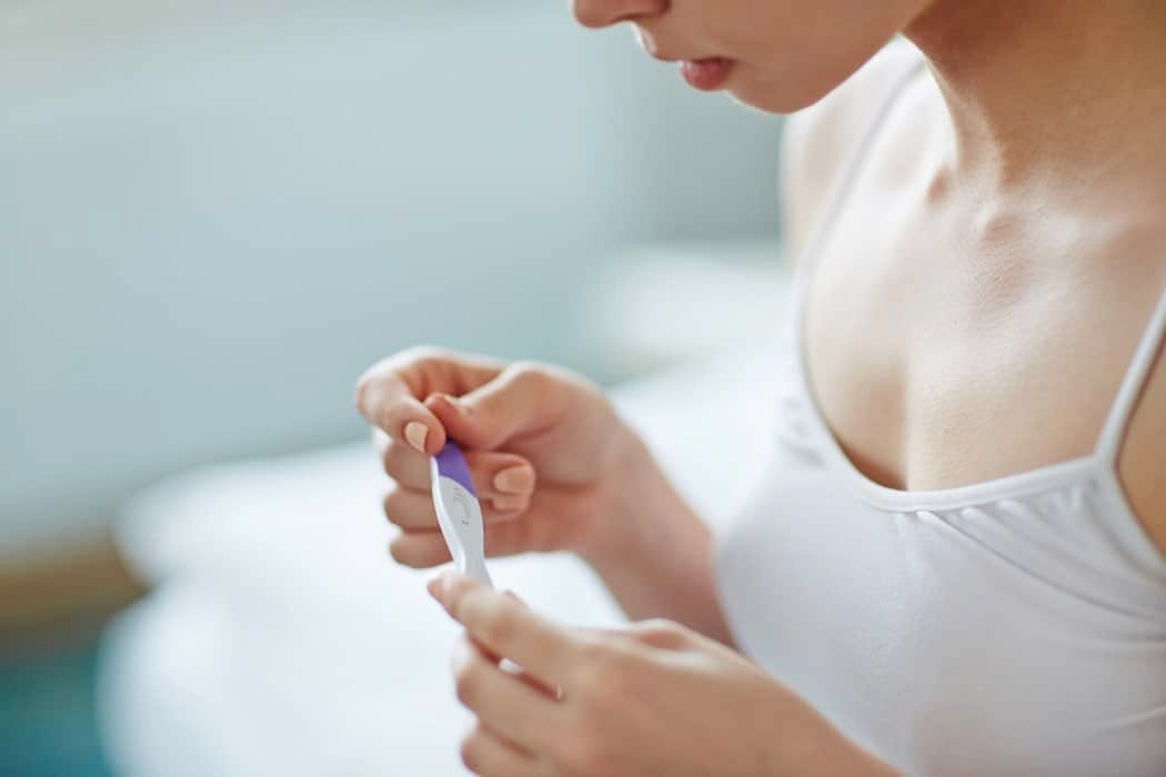 pregnant woman looking at test
