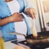 Pregnant, cooking and woman in kitchen in home