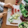pregnant woman chopping vegetables for meal