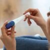Young woman looking at pregnancy test