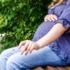 Pregnant Woman Smoking Cigarette Outdoor in park