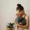 Mother holds and hugs her newborn baby son at home
